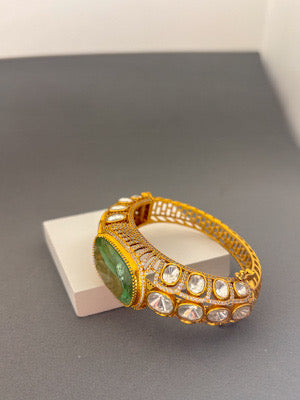 Elegant Gold Bracelet with Green Gemstone and Clear Stone Accents