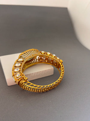 Elegant Gold Bracelet with Green Gemstone and Clear Stone Accents
