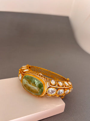 Elegant Gold Bracelet with Green Gemstone and Clear Stone Accents